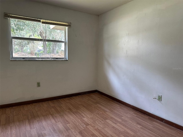 empty room with hardwood / wood-style floors