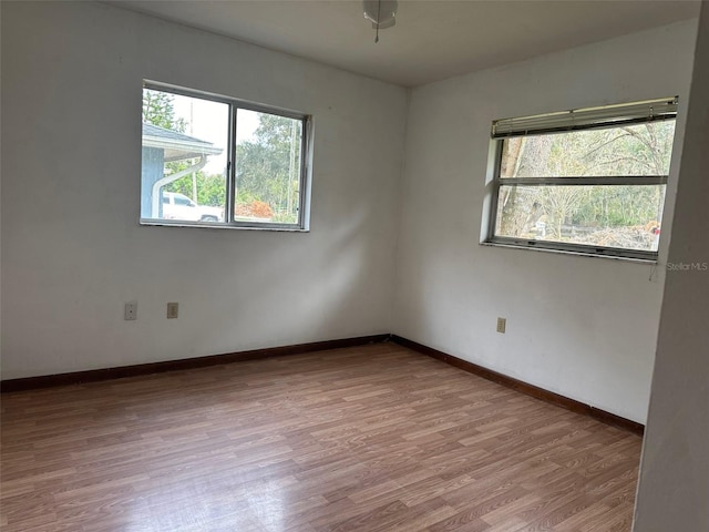 empty room featuring light hardwood / wood-style flooring and a wealth of natural light