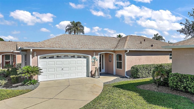 single story home featuring a garage and a front lawn