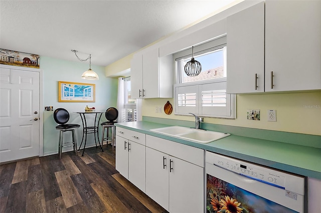 kitchen featuring dishwasher, dark wood-type flooring, sink, pendant lighting, and white cabinets