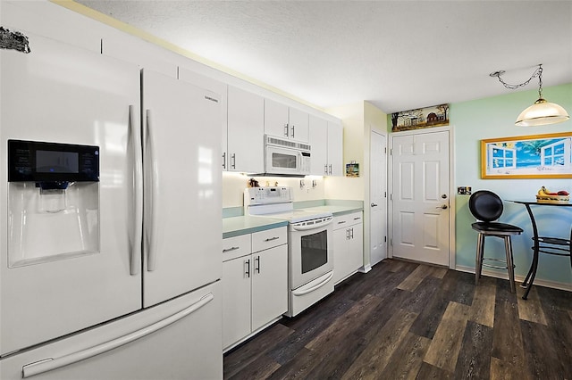 kitchen with dark hardwood / wood-style floors, hanging light fixtures, white cabinetry, a textured ceiling, and white appliances