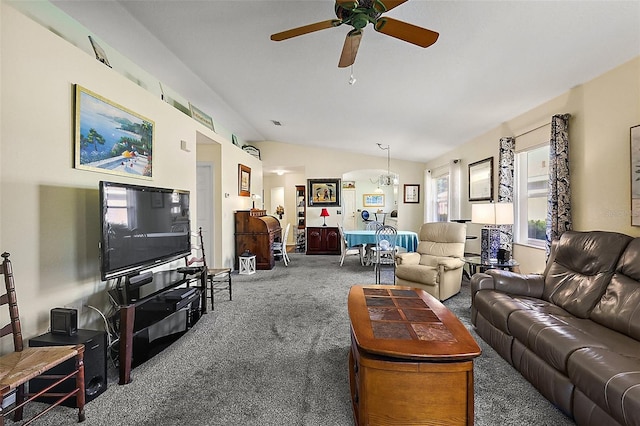 carpeted living room with vaulted ceiling and ceiling fan with notable chandelier