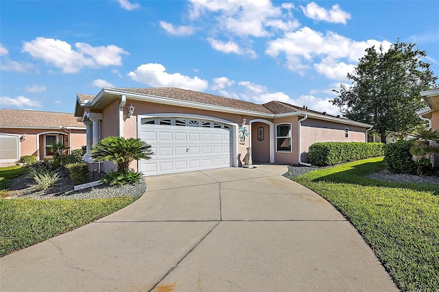 view of front of home with a front yard and a garage