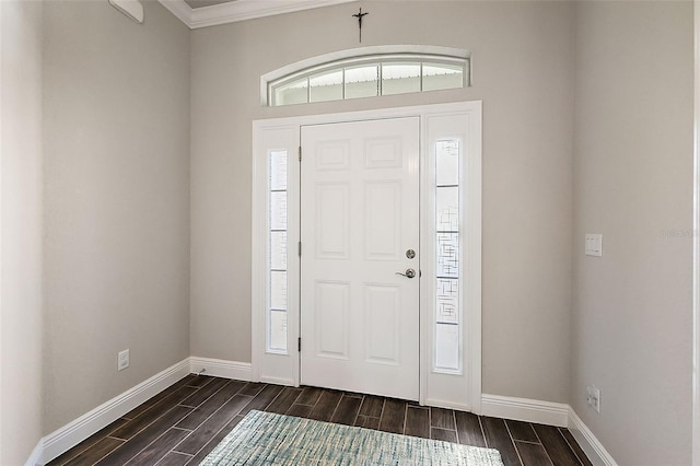 foyer entrance with crown molding and dark hardwood / wood-style floors