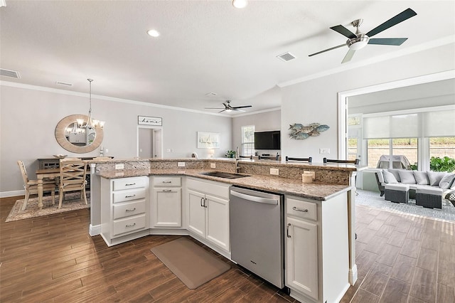 kitchen featuring dark hardwood / wood-style flooring, white cabinetry, dishwasher, sink, and decorative light fixtures