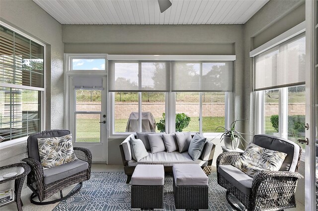 sunroom featuring plenty of natural light, an outdoor hangout area, and ceiling fan