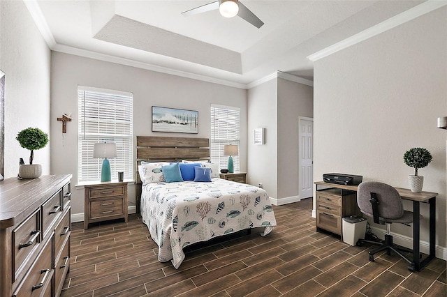 bedroom featuring a tray ceiling, ornamental molding, baseboards, and wood tiled floor