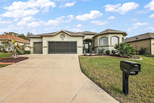 mediterranean / spanish home featuring a front yard and a garage