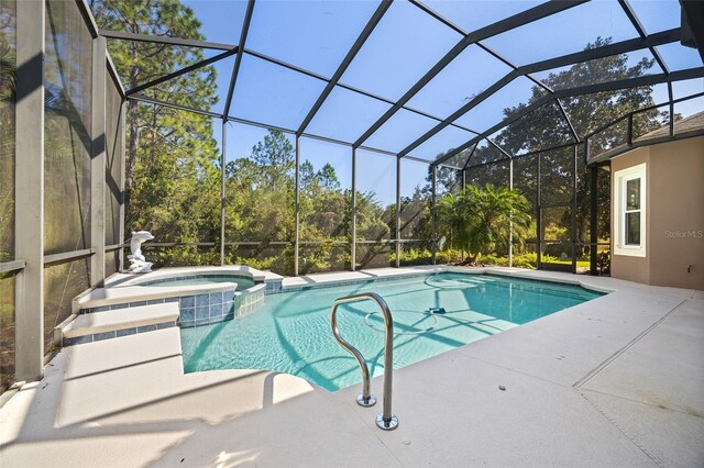 view of pool with an in ground hot tub, a patio, and glass enclosure