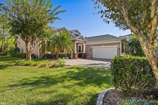 view of front of house featuring a garage and a front yard