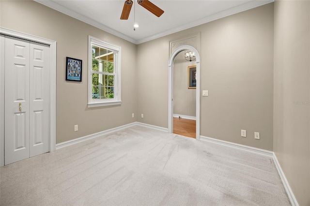 carpeted spare room featuring crown molding, recessed lighting, a ceiling fan, and baseboards