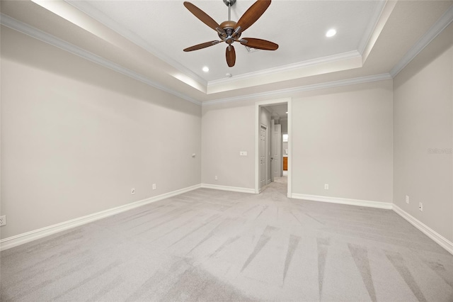 unfurnished room with baseboards, light colored carpet, a tray ceiling, ornamental molding, and recessed lighting