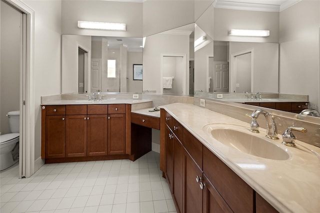 bathroom featuring two vanities, crown molding, toilet, and a sink