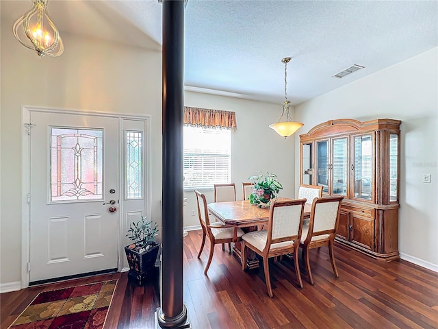 dining area featuring a textured ceiling and dark hardwood / wood-style floors