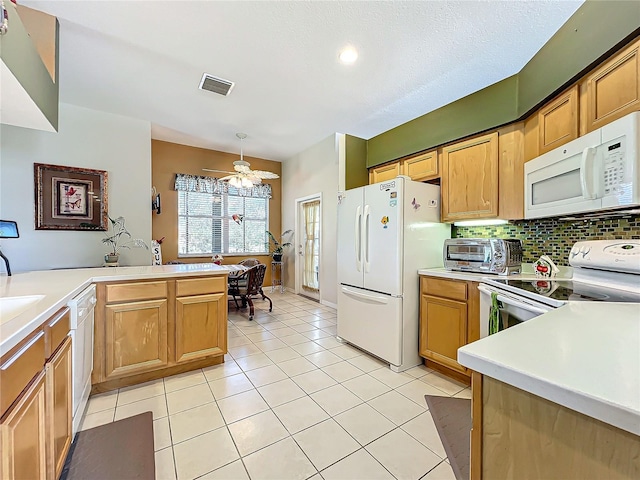 kitchen featuring white appliances, light tile patterned floors, decorative backsplash, kitchen peninsula, and ceiling fan