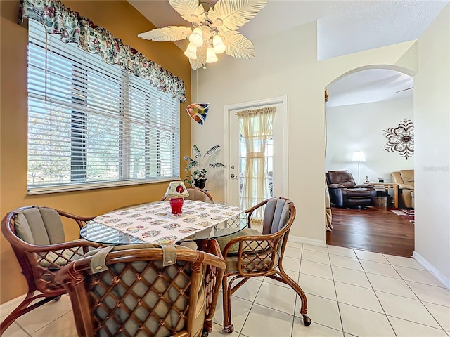 dining area featuring ceiling fan and light tile patterned floors