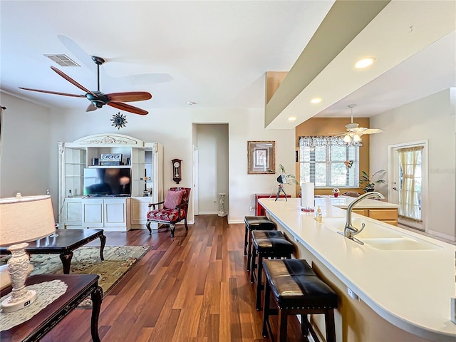 kitchen with dark wood-type flooring and a kitchen bar