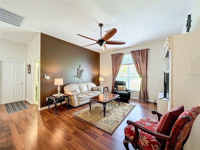 living room featuring dark hardwood / wood-style floors and ceiling fan