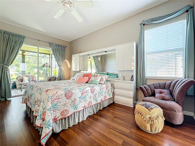 bedroom with dark wood-type flooring, access to outside, multiple windows, and ceiling fan