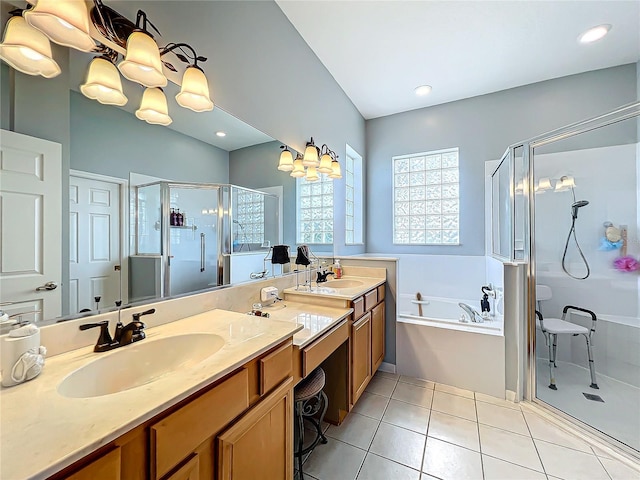 bathroom with tile patterned flooring, vanity, and plus walk in shower