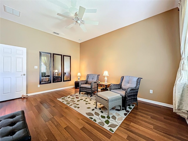 sitting room with hardwood / wood-style floors and ceiling fan