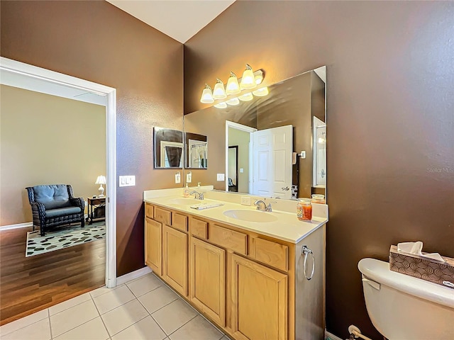 bathroom with hardwood / wood-style floors, vanity, and toilet