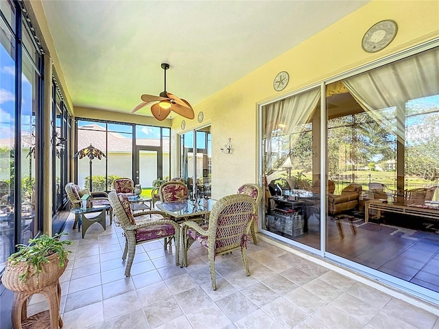 sunroom / solarium featuring a wealth of natural light and ceiling fan