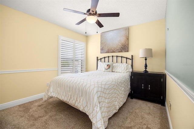 carpeted bedroom with a textured ceiling and ceiling fan