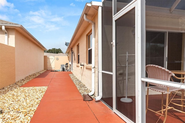 view of side of home featuring a patio area