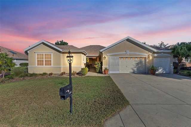 ranch-style house with a garage and a yard