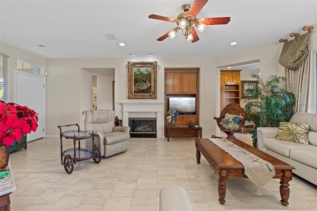 living room featuring ceiling fan and light tile patterned flooring