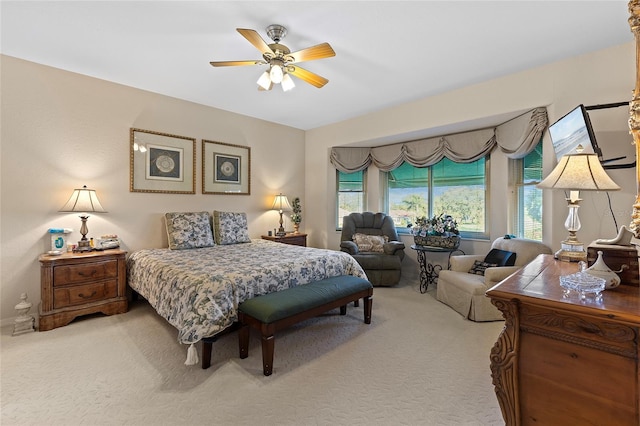 carpeted bedroom featuring multiple windows and ceiling fan