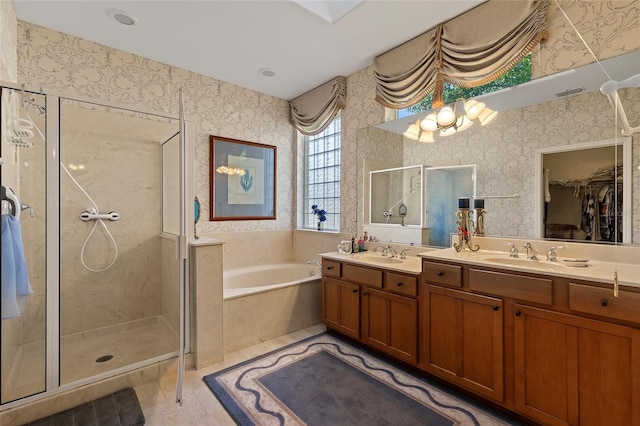 bathroom featuring tile patterned flooring, vanity, and plus walk in shower