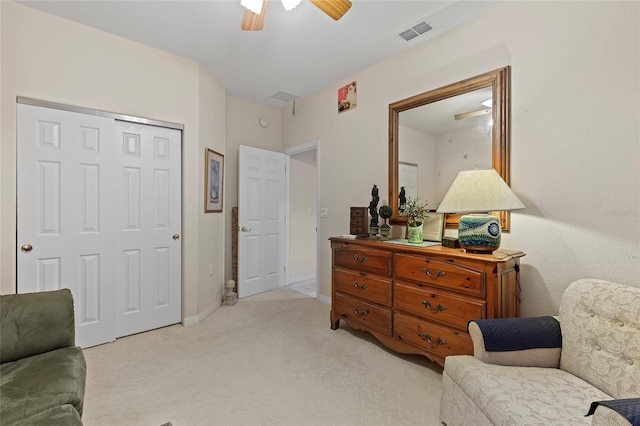 sitting room with light colored carpet and ceiling fan