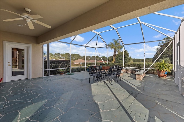 view of patio / terrace with ceiling fan and a lanai