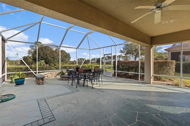 view of patio featuring a lanai and ceiling fan