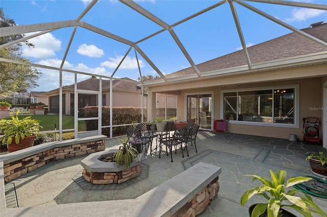 view of patio / terrace with a lanai, french doors, and a fire pit