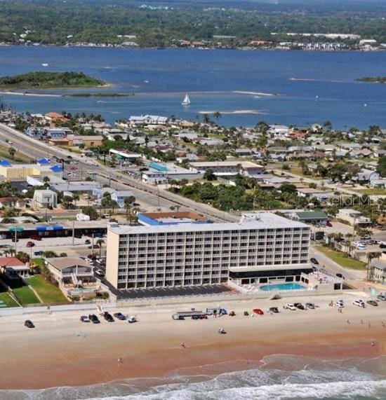 bird's eye view with a water view and a beach view