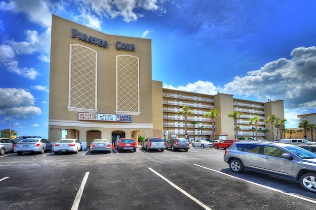 view of building exterior with uncovered parking