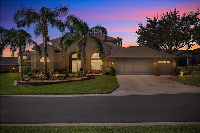 view of front facade featuring a garage and a lawn