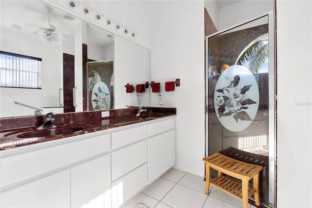 bathroom with vanity, walk in shower, ceiling fan, and tile patterned flooring