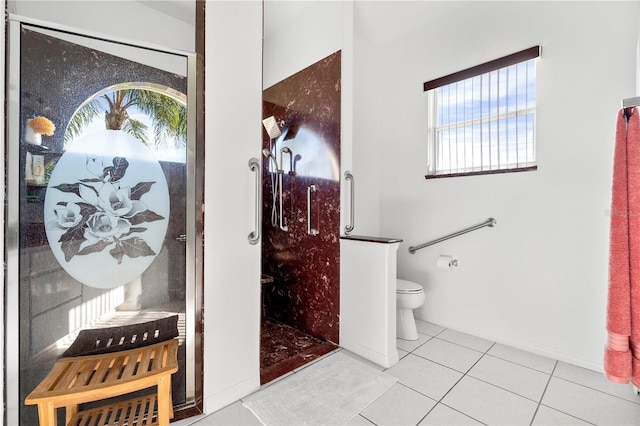 bathroom featuring a shower with door, toilet, and tile patterned flooring