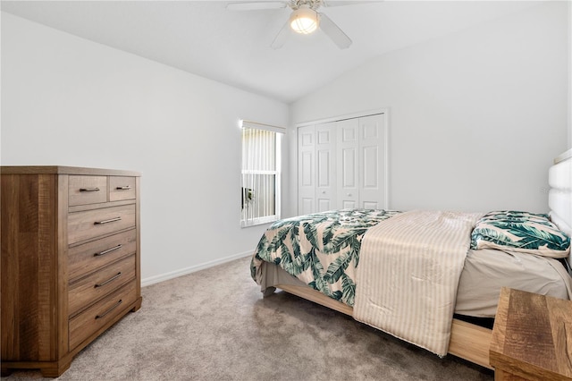 bedroom with a closet, vaulted ceiling, carpet, and ceiling fan