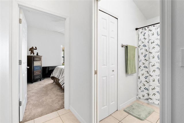 bathroom with a shower with curtain and tile patterned flooring