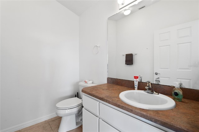 bathroom featuring vanity, toilet, and tile patterned flooring