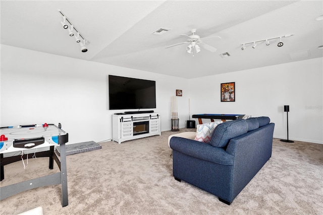 living room featuring track lighting, carpet floors, and ceiling fan