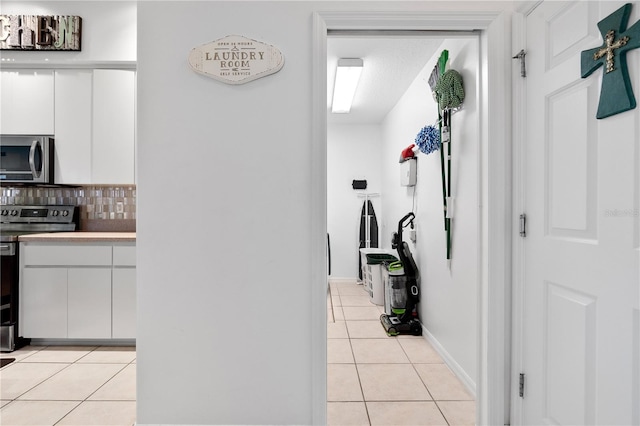 hall featuring light tile patterned floors