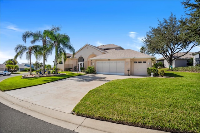 mediterranean / spanish home featuring a front lawn and a garage