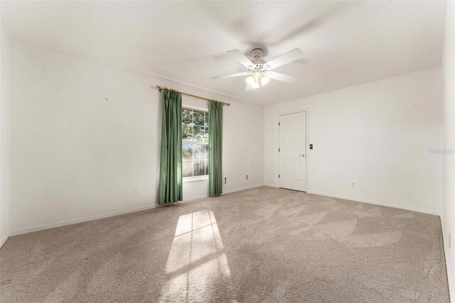 unfurnished room featuring carpet flooring and ceiling fan