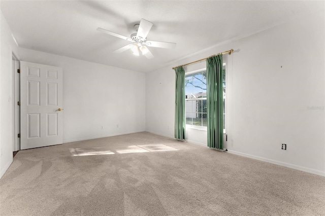 carpeted empty room featuring ceiling fan